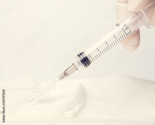 Health nurse worker with vaccine syringe. Concept vacine for healty lifestyle. Toned Image.