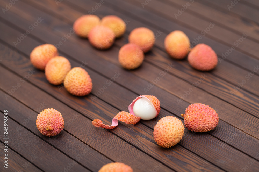 Lychees fruits on wooden background. Litchi on wood background with copy space