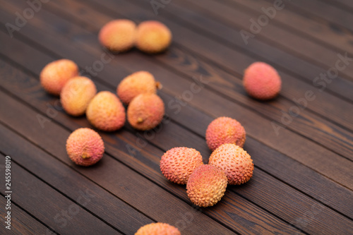 Lychees fruits on wooden background. Litchi on wood background with copy space