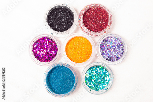small colorful jars of glitter and sequins for body tattoo close-up