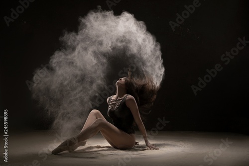 Brunette on the floor in white dust cloud