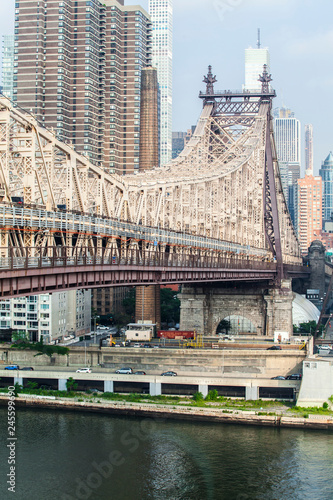 View of Ed Koch Queensboro Bridge that connects Manhattan with Queens on East River during sunny summer day photo