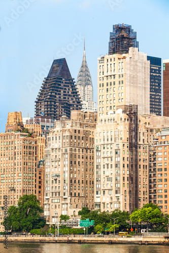 View of Manhattan skyline viewed from East River during sunny summer day