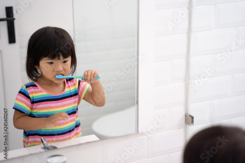 toddler independently brush her own teeth