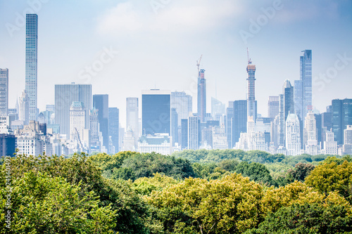 Futuristic look of Manhattan skyline viewed from Central Park in New York City during sunny summer day