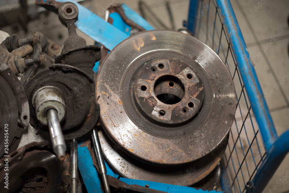 Worn out rusty brake discs and other parts - Image