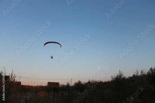 silhouette of a paraglider in the sunset