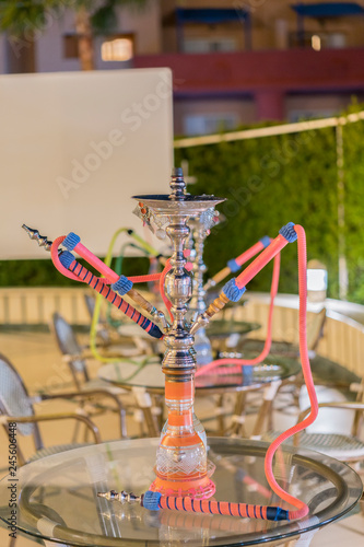 hookah in the restaurant, hookah elements on the background of a blurry interior of the restaurant, a cafe with a bokeh. vertical photo. © jollier_
