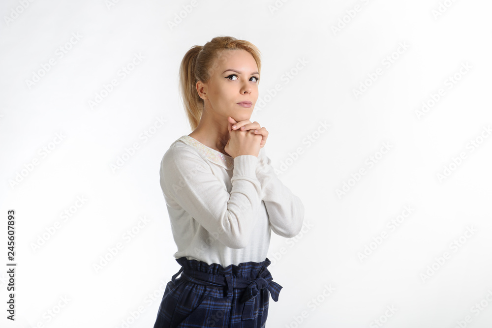 lateral view of a 20-years blond girl in white blouse and blue skirt on white background thinking about something lateral view of a 20-years blond girl in white blouse and blue skirt on white background thinking about something