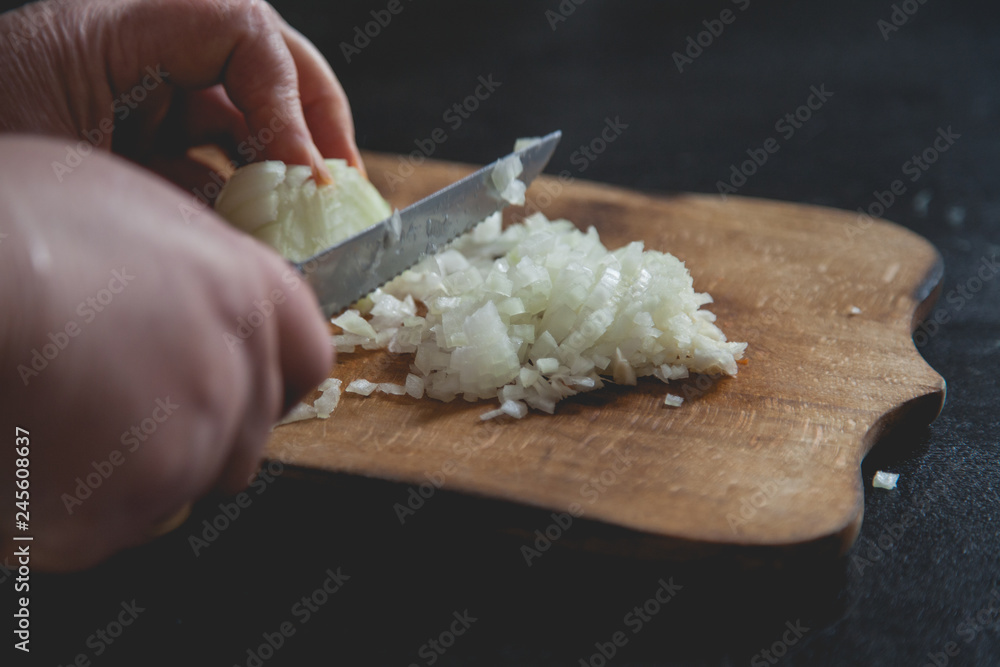 cutting white onion with knife 