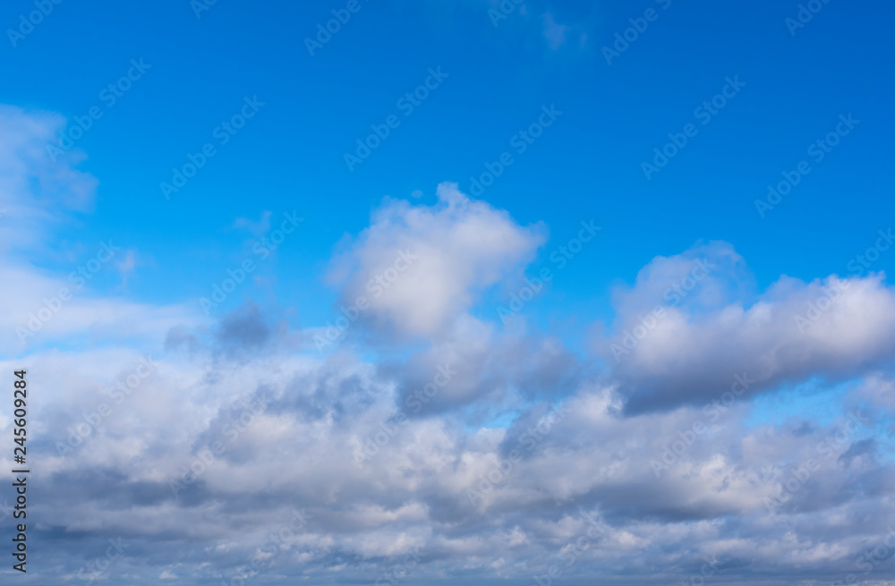 Cumulus clouds covering bottom of image. Clear sky above