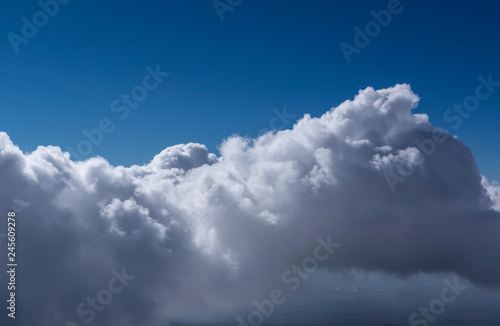 White cumulus clouds seen from top of volcano