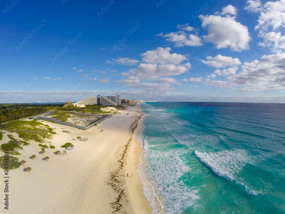 Playa Delfines, Cancun, Mexico. Aerial view on beach and coast of Caribbean sea against blue sky. Top view
