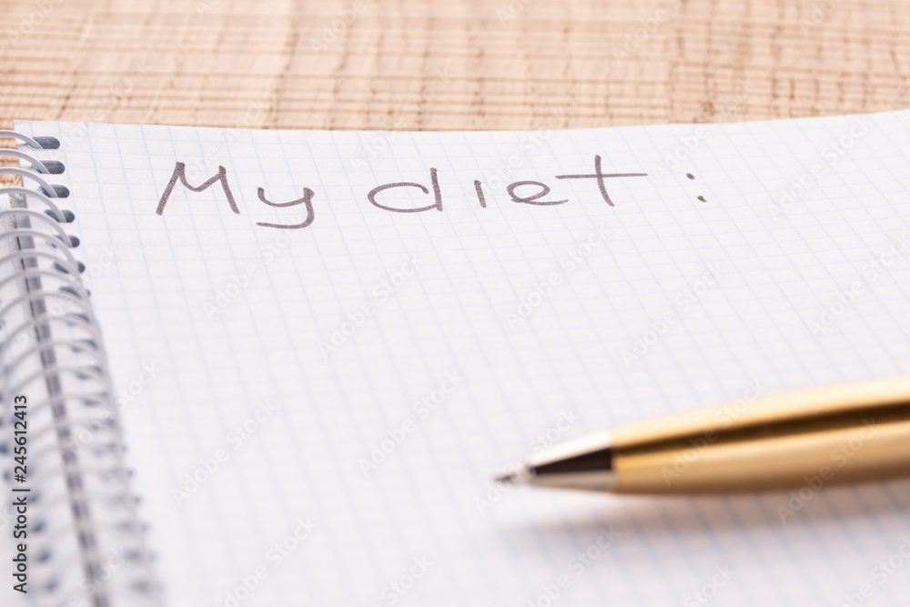 Top view workplace notebook and pen on wood table background, retro effect. Inscription - My diet. Top view workplace notebook and pen on wood table background, retro effect. Inscription - My diet.