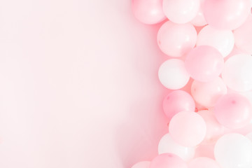 Balloons on pastel pink background. Frame made of white and pink balloons. Birthday, valentines day, holiday concept. Flat lay, top view, copy space
