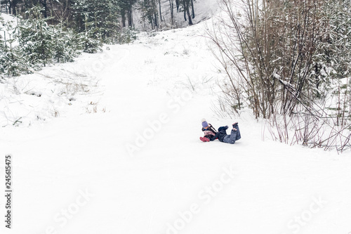 children play on a snow hill