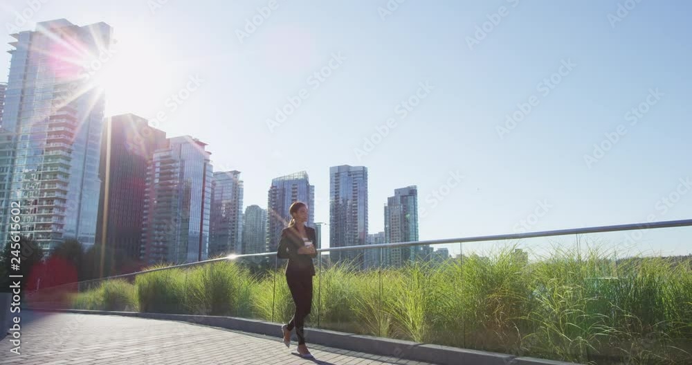 Businesswoman in suit in city walking holding coffee. Young woman professional in. Vancouver, Canada, Shot on RED in SLOW MOTION Businesswoman in suit in city walking holding coffee. Young woman professional in. Vancouver, Canada, Shot on RED in SLOW MOTION