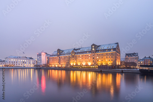 Schilderij op canvas View of Admiral Hotel in Copenhagen during sunset with reflection in the water, seen from the shore