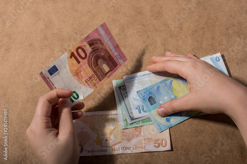 Hand holding American dollar  isolated on wooden background photo