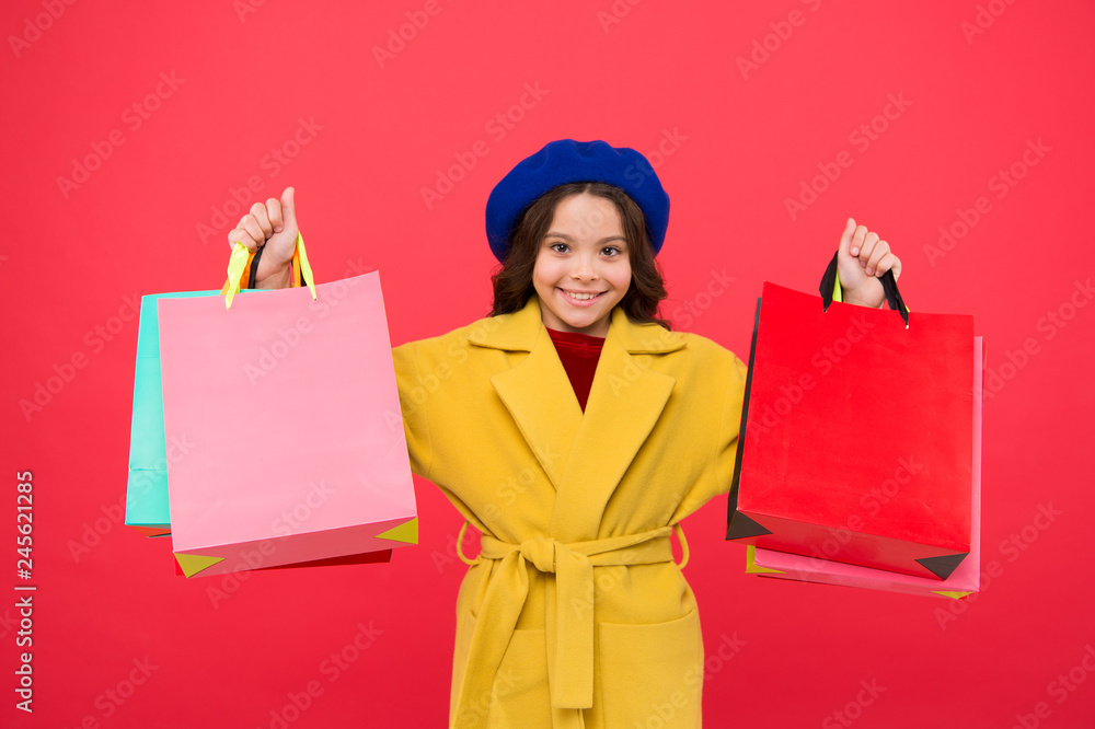 Get major wardrobe refresh with spring sales at stores. Girl cute kid hold shopping bags red background. Get discount shopping on birthday holiday. Fashionista adore shopping. Obsessed with shopping Get major wardrobe refresh with spring sales at stores. Girl cute kid hold shopping bags red background. Get discount shopping on birthday holiday. Fashionista adore shopping. Obsessed with shopping