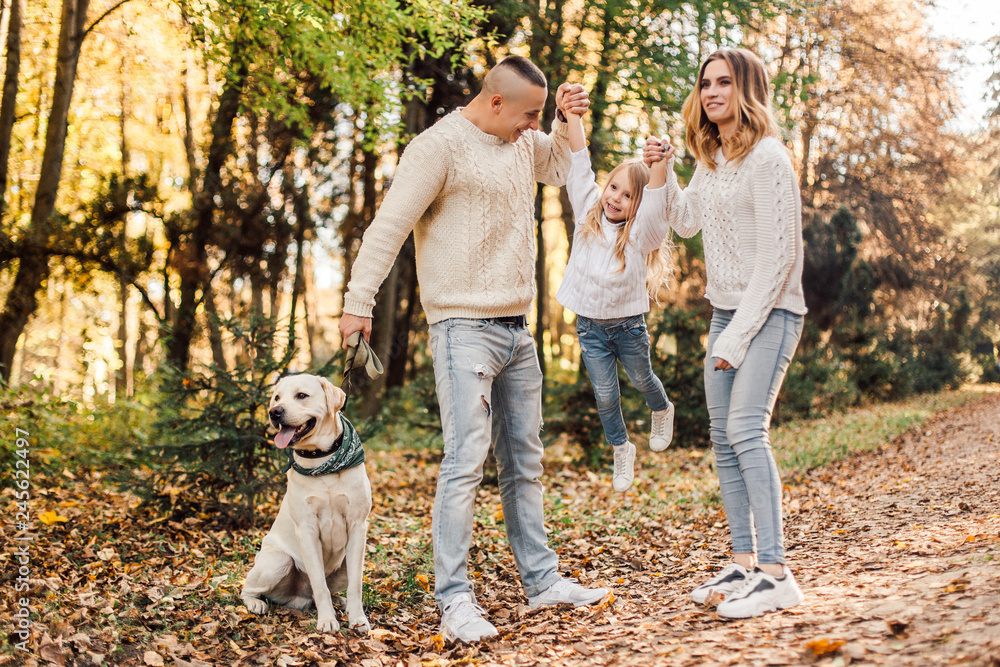 Happy family is having fun with dog labrador outdoors. Happy family is having fun with dog labrador outdoors.