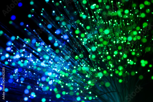 bundle of optic fibers in blue and green light