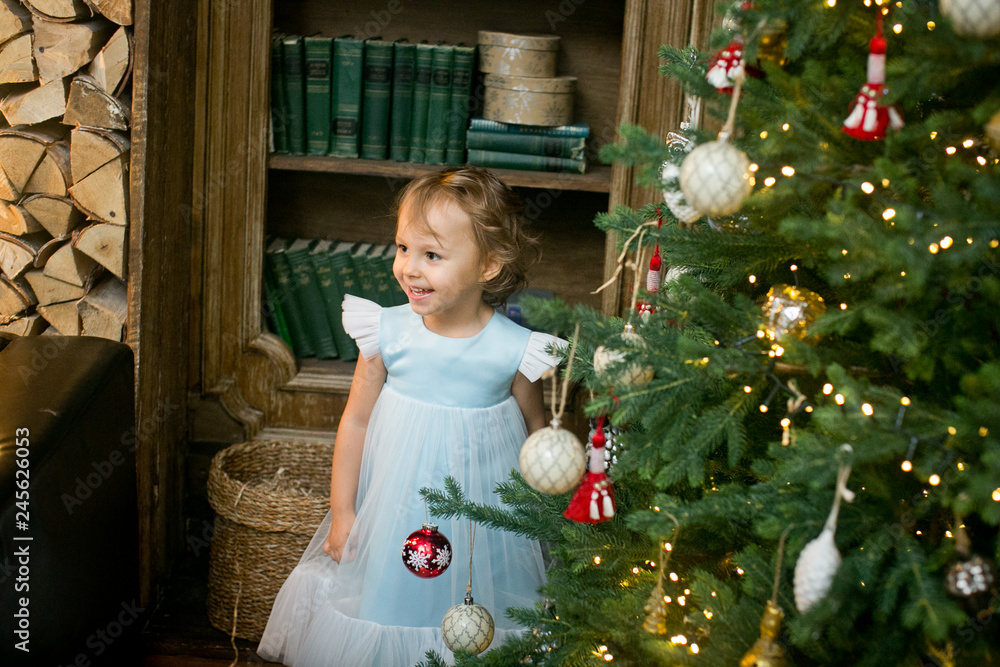little girl under the christmas tree with christmas gifts little girl under the christmas tree with christmas gifts
