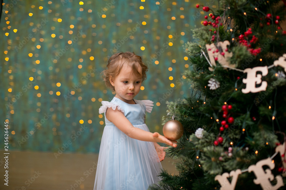 little girl under the christmas tree with christmas gifts little girl under the christmas tree with christmas gifts
