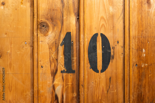 Photography number 10 on door of storage room for tenants in century-old apartment building