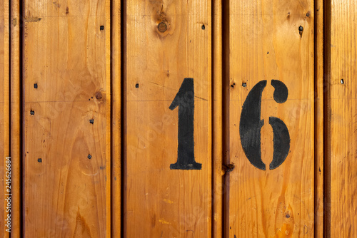 Photography number 16 on door of storage room for tenants in century-old apartment building