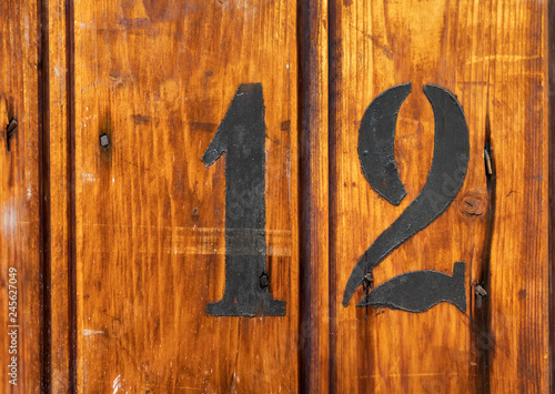 Canvas Print number 12 on door of storage room for tenants in century-old apartment building