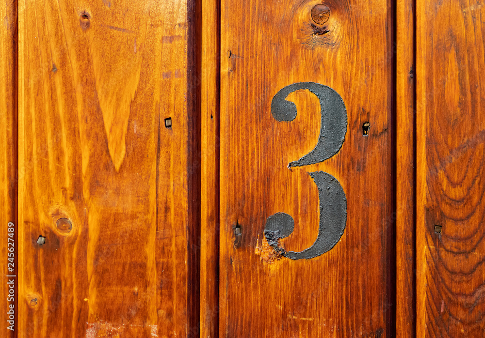number 3 on door of storage room for tenants in century-old apartment building in stockholm number 3 on door of storage room for tenants in century-old apartment building in stockholm