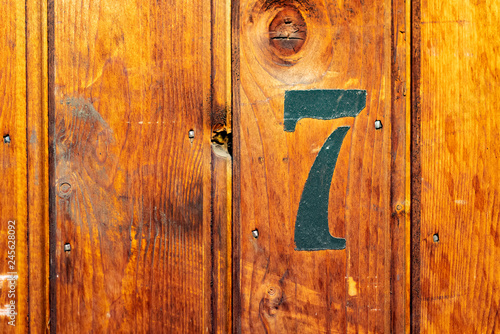 number 7 on door of storage room for tenants in century-old apartment building in stockholm