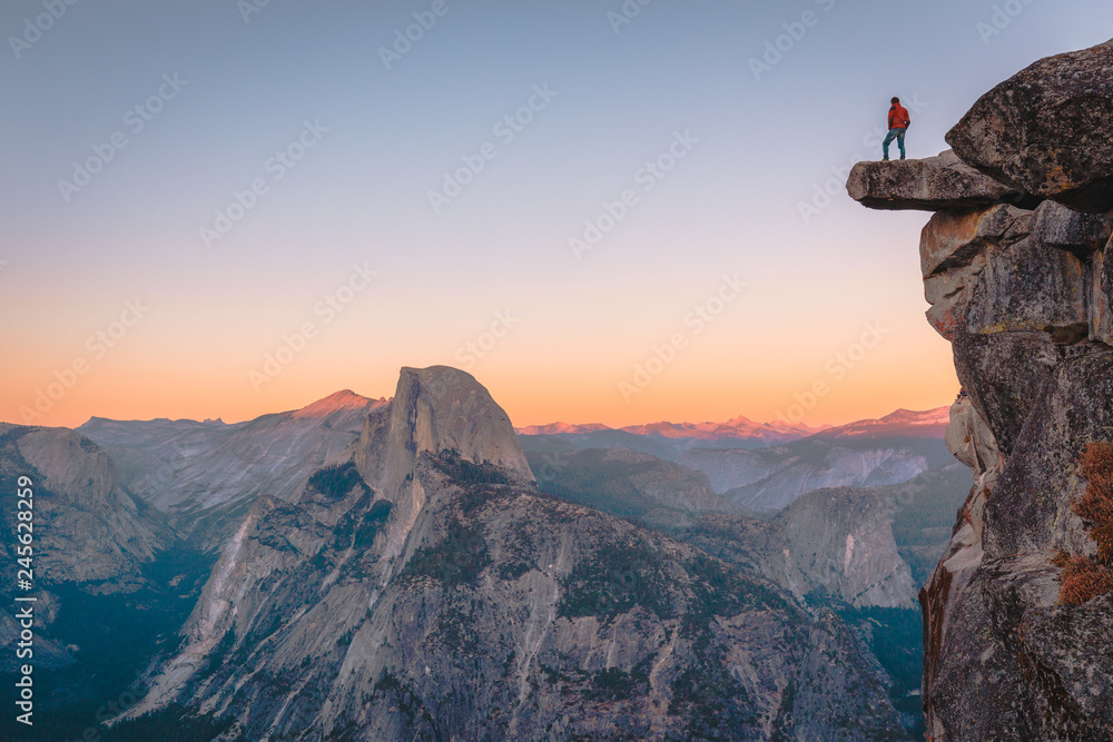 Hiker on a cliff in Yosemite National Park, California, USA