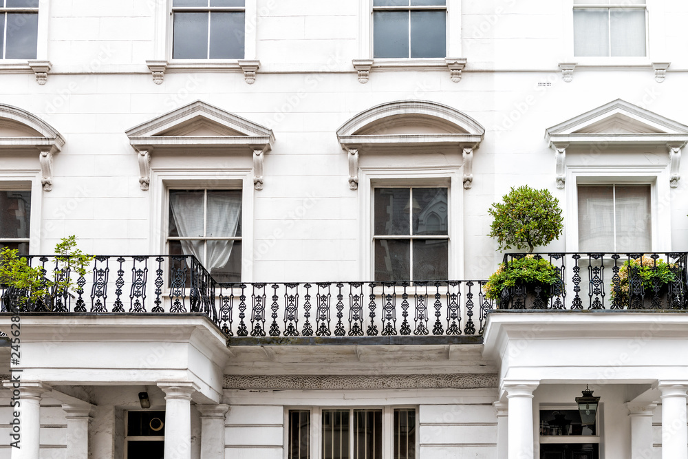 London, UK closeup of neighborhood district of Kensington luxury white architecture and nobody terraced buildings balconies