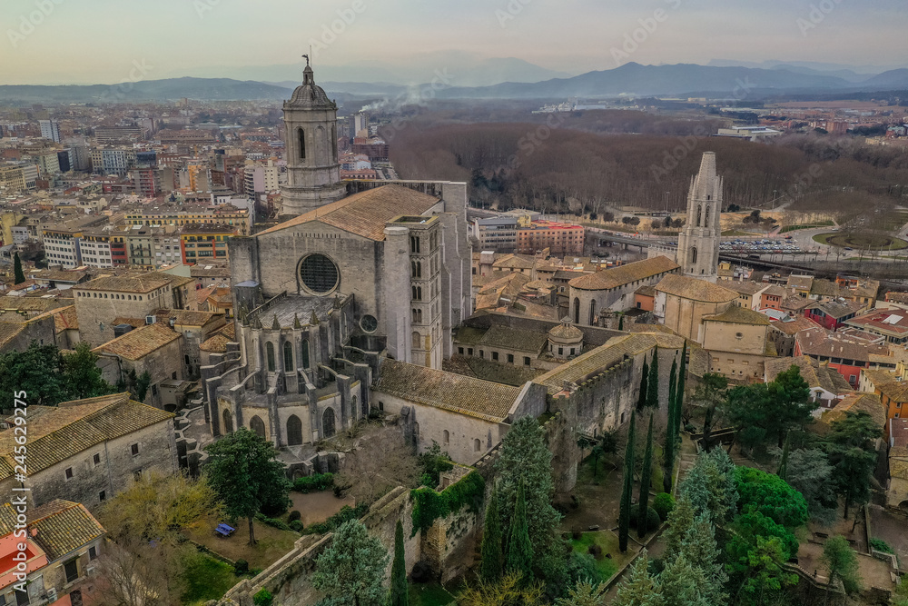 Aerial panorama view of medieval Girona with Gothic St Mary Roman Catholic cathedral, city walls and colorful houses at sunset in Girona Catalonia Spain