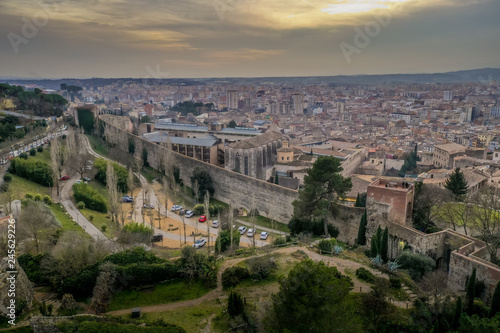 Aerial panorama view of medieval Girona with Gothic St Mary Roman Catholic cathedral, city walls and colorful houses at sunset in Girona Catalonia Spain