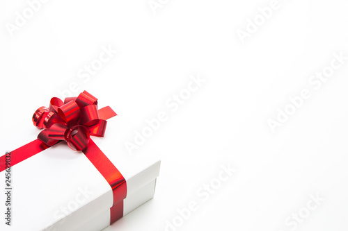 One White Christmas Gift Box Wrapped in Red Ribbon Placed on white Background.