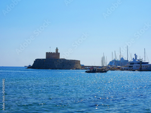 Fototapeta Naklejka Na Ścianę i Meble -  The entrance to Mandraki Harbour on the island of Rhodes Greece