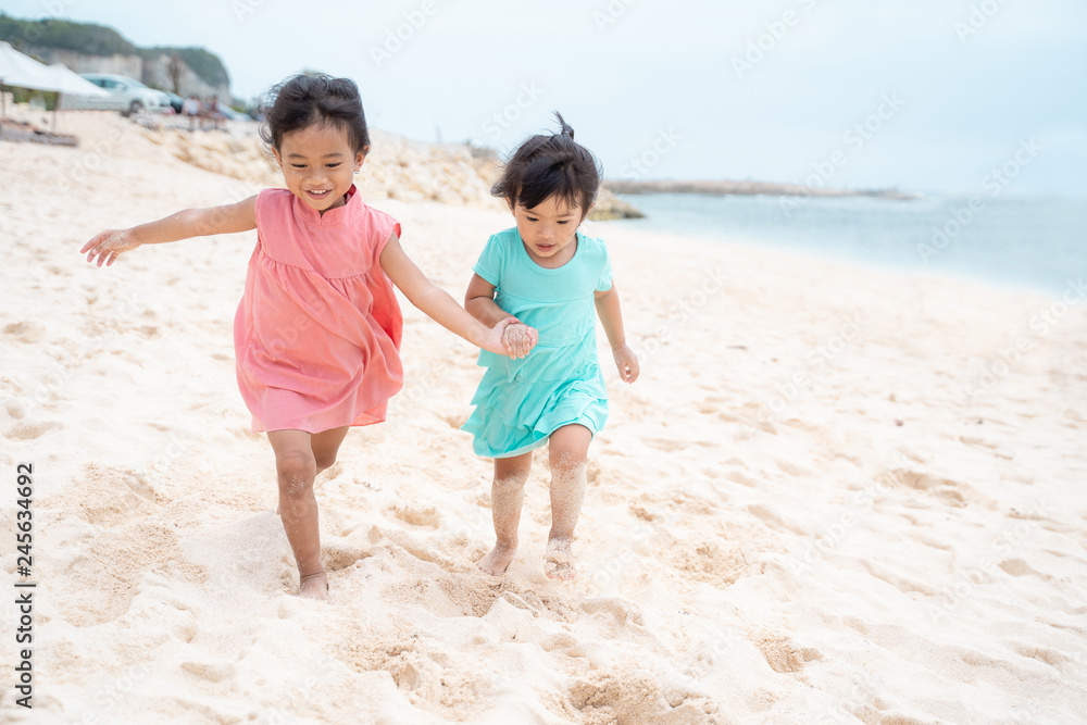 two little girl running with hold hand enjoy playing together