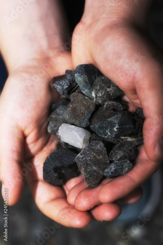 A close up coal rocks being held in a hand.