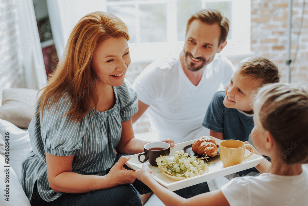 Happy children bringing breakfast to parents in bed Happy children bringing breakfast to parents in bed