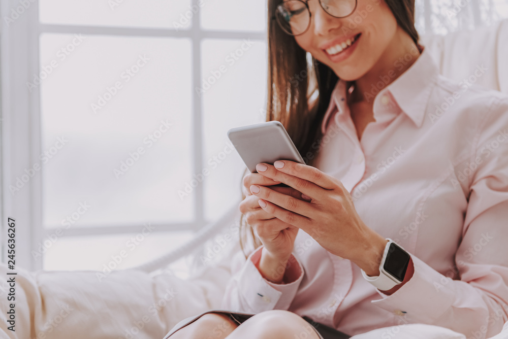 Charming asian girl watching at mobile phone Charming asian girl watching at mobile phone