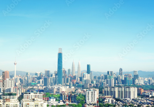 Cityscape of Kuala lumpur city skyline on blue sky with sunlight in Malaysia at daytime.