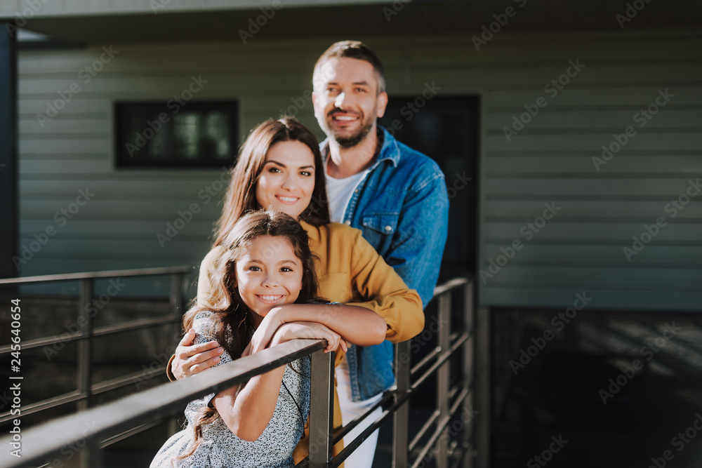 Obraz premium Smiling couple with daughter are locating outdoor
