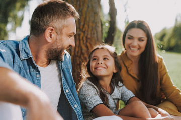 Smiling family is spending nice weekend outdoor