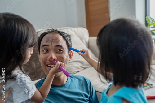 daughter painting on her dad s face