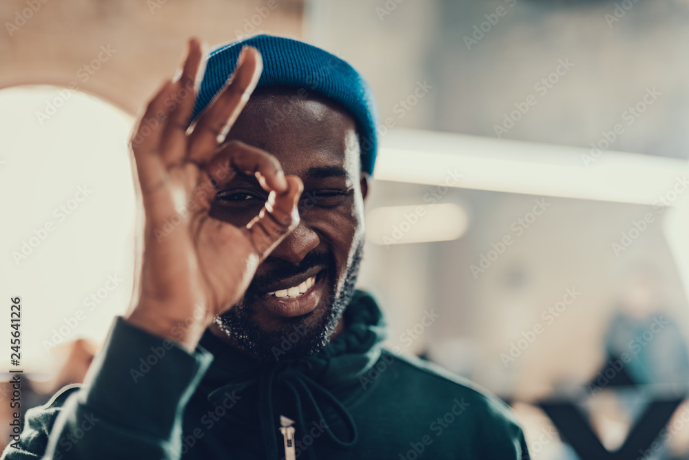 Afro-American man smiling and showing ok gesture