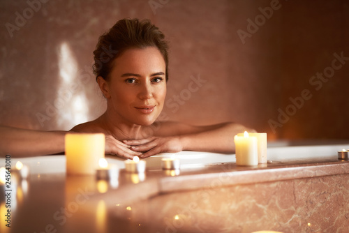 Close up of young lady taking relaxed bath
