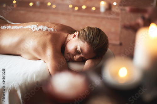 Lady on massage table with mineral salt